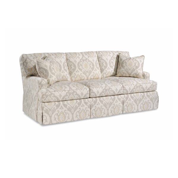 Traditional skirted sofa with neutral damask pattern and matching pillows.