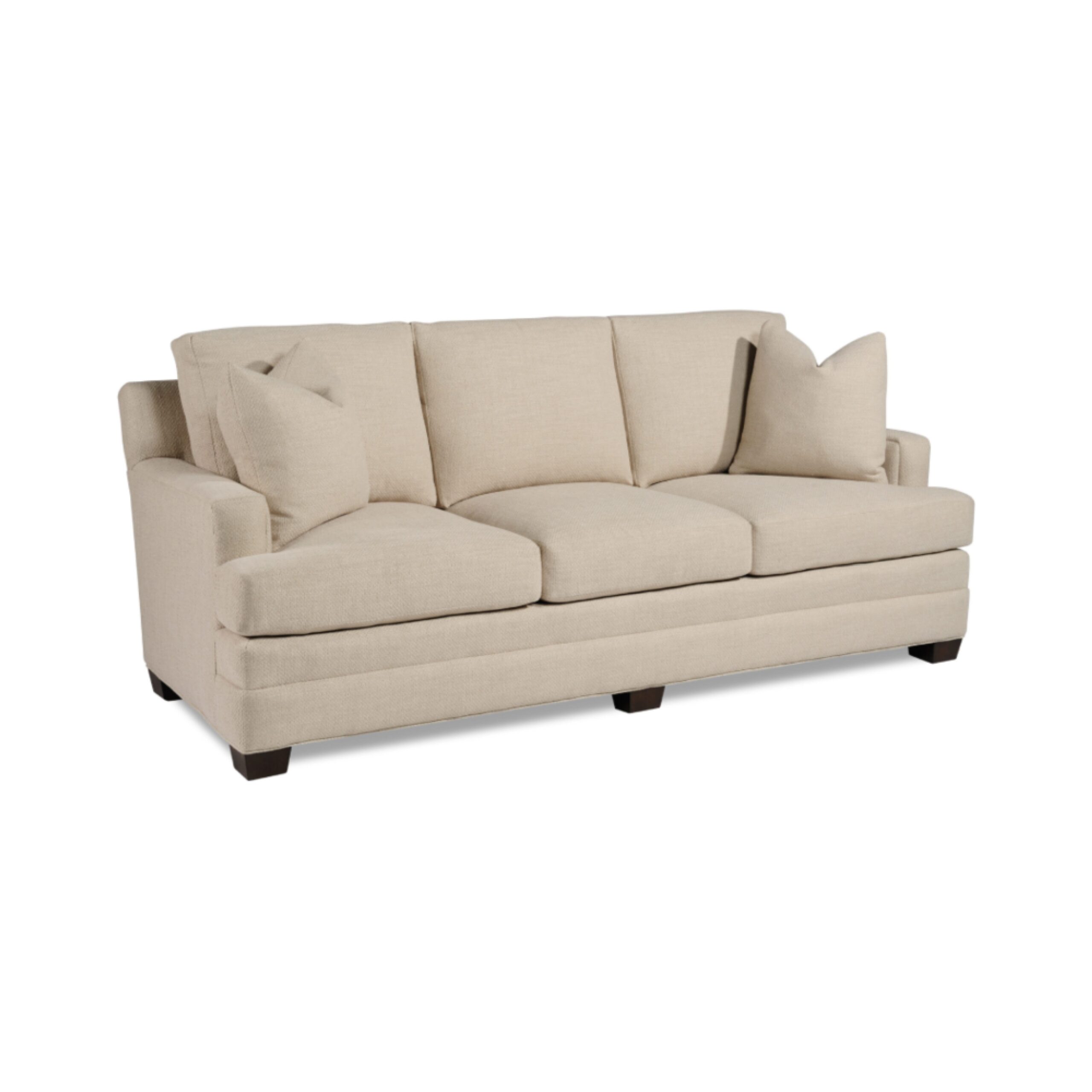 taylor made standard sofa Elegant cream three-seater sofa with matching accent pillows.