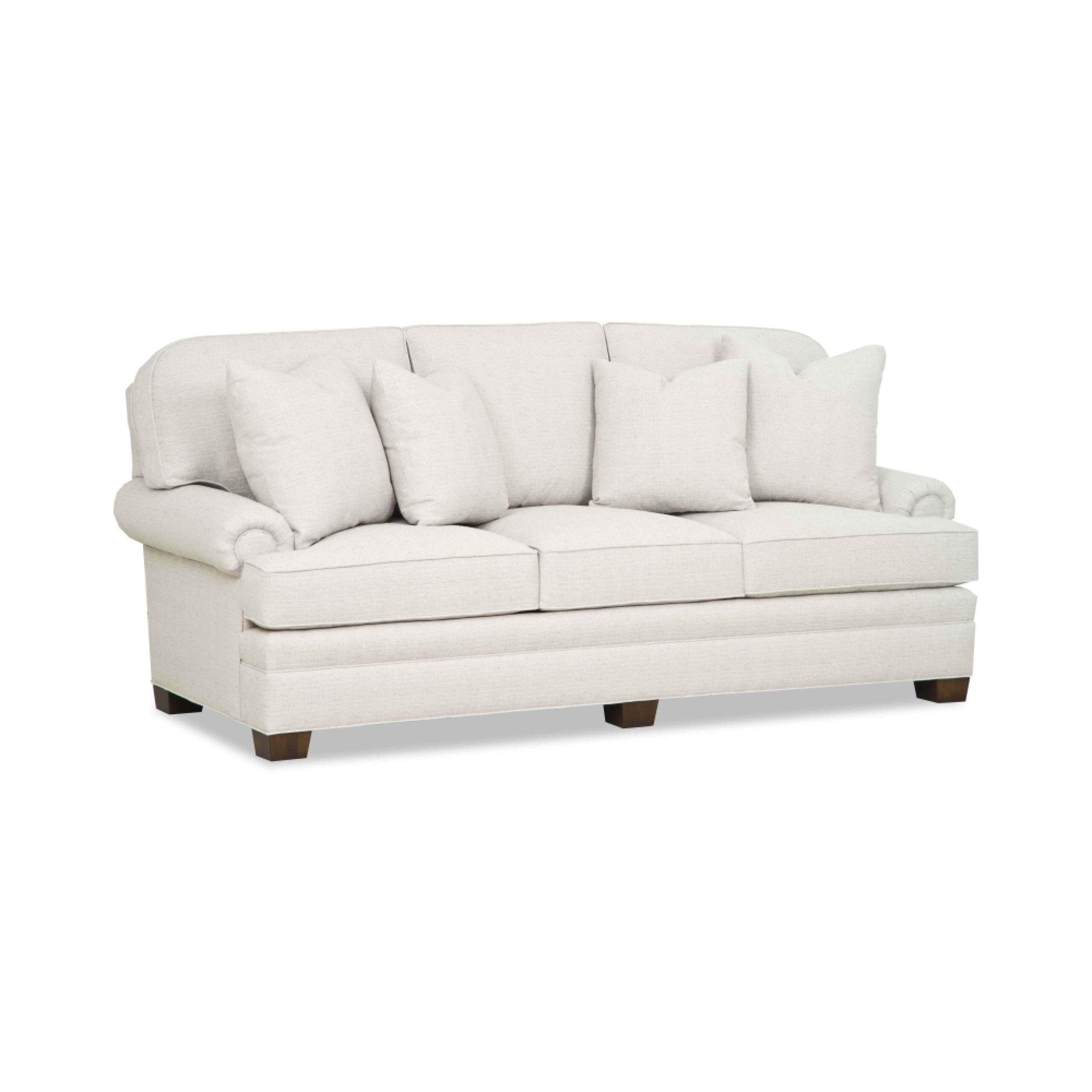 taylor made tall sofa Traditional cream three-seater sofa with rolled arms and pillows.