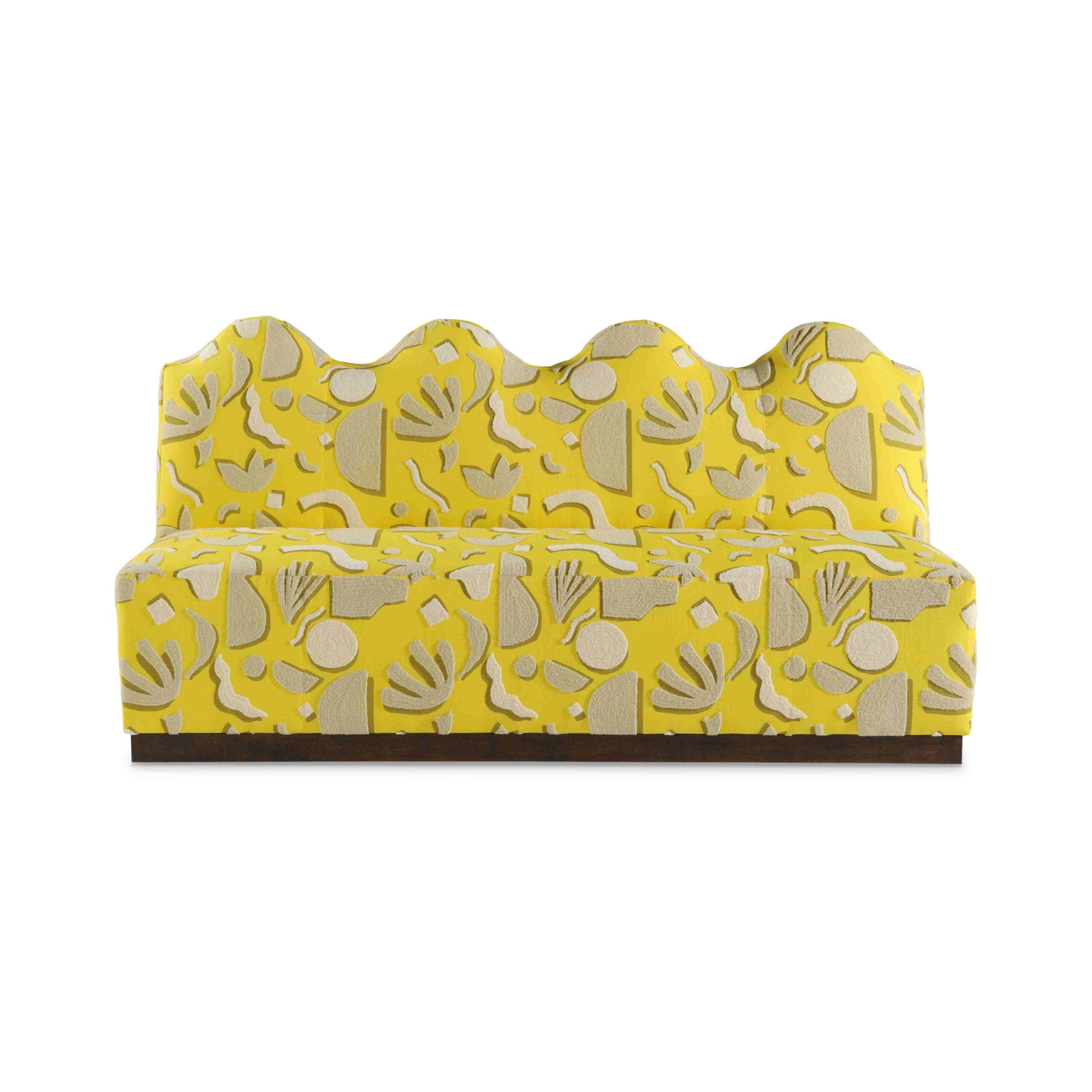 wave banquette Yellow patterned sofa with a scalloped backrest and wood base.