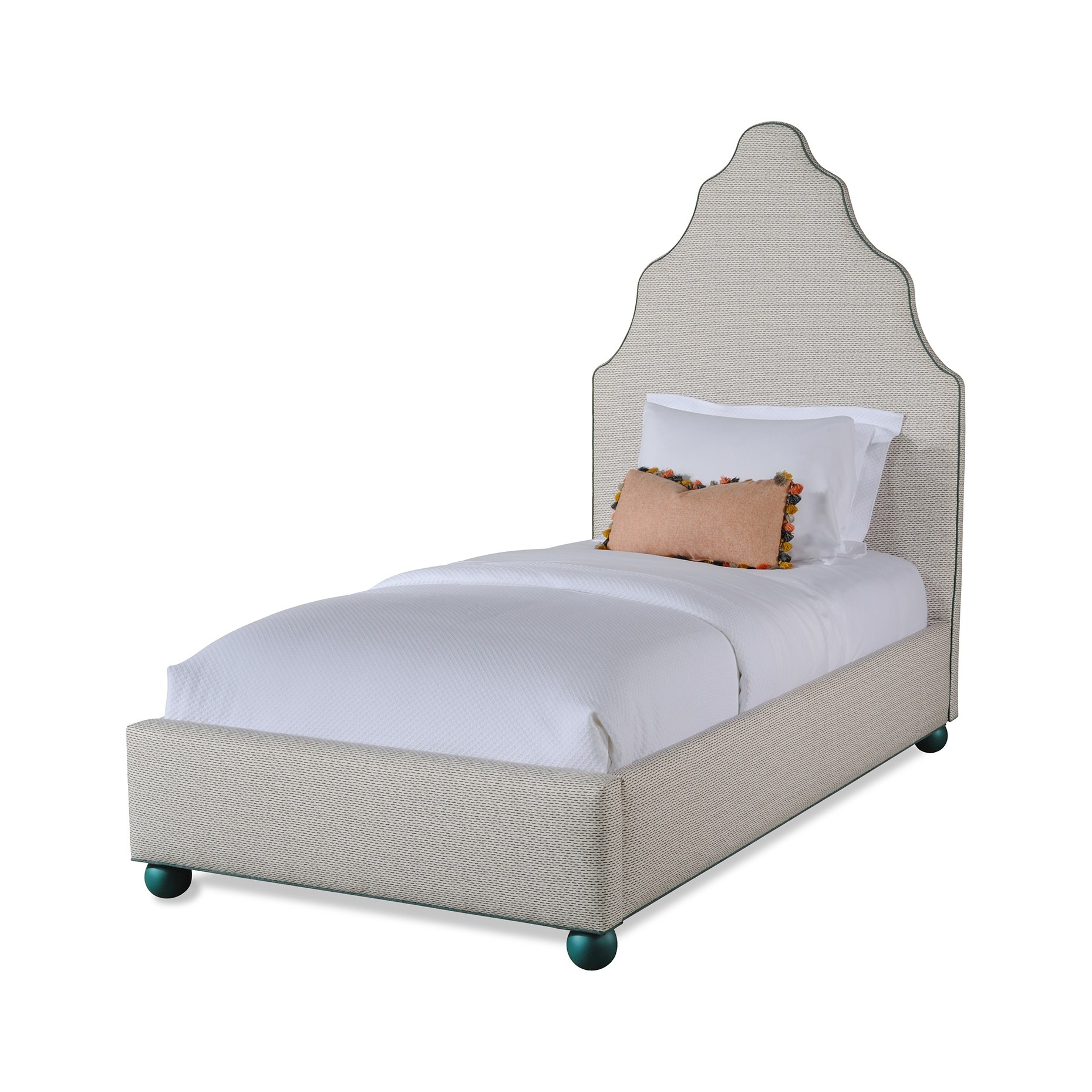 serena bed Upholstered single bed with tall scalloped headboard and white bedding.