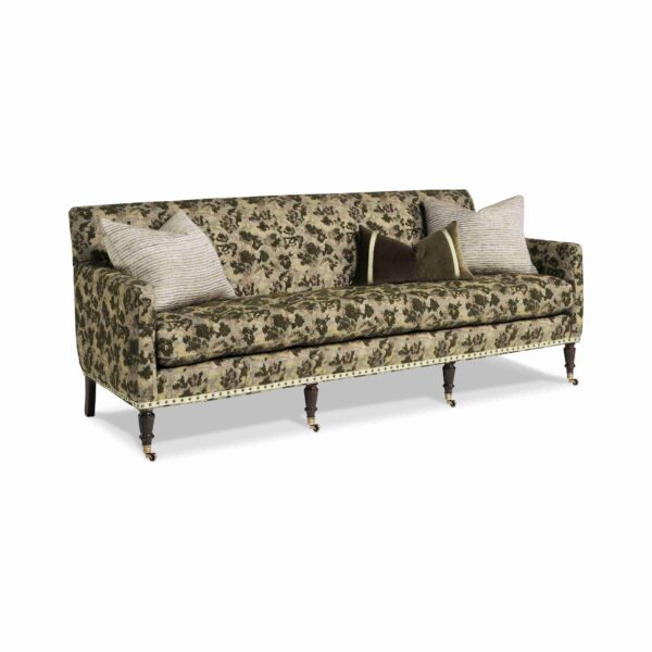 Traditional floral sofa with turned legs and brass casters.
