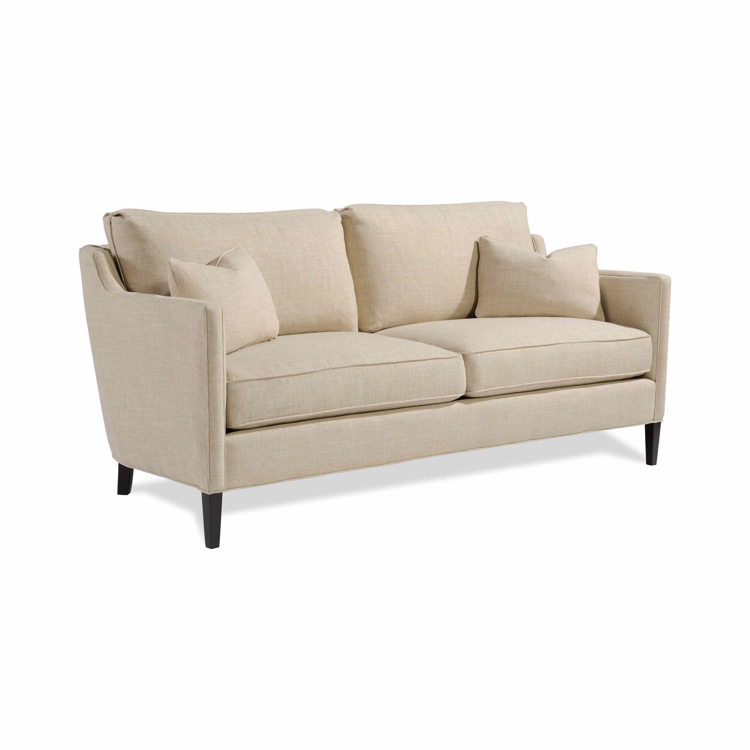 callahan mini sofa Cream two-seater sofa with matching pillows and dark legs.