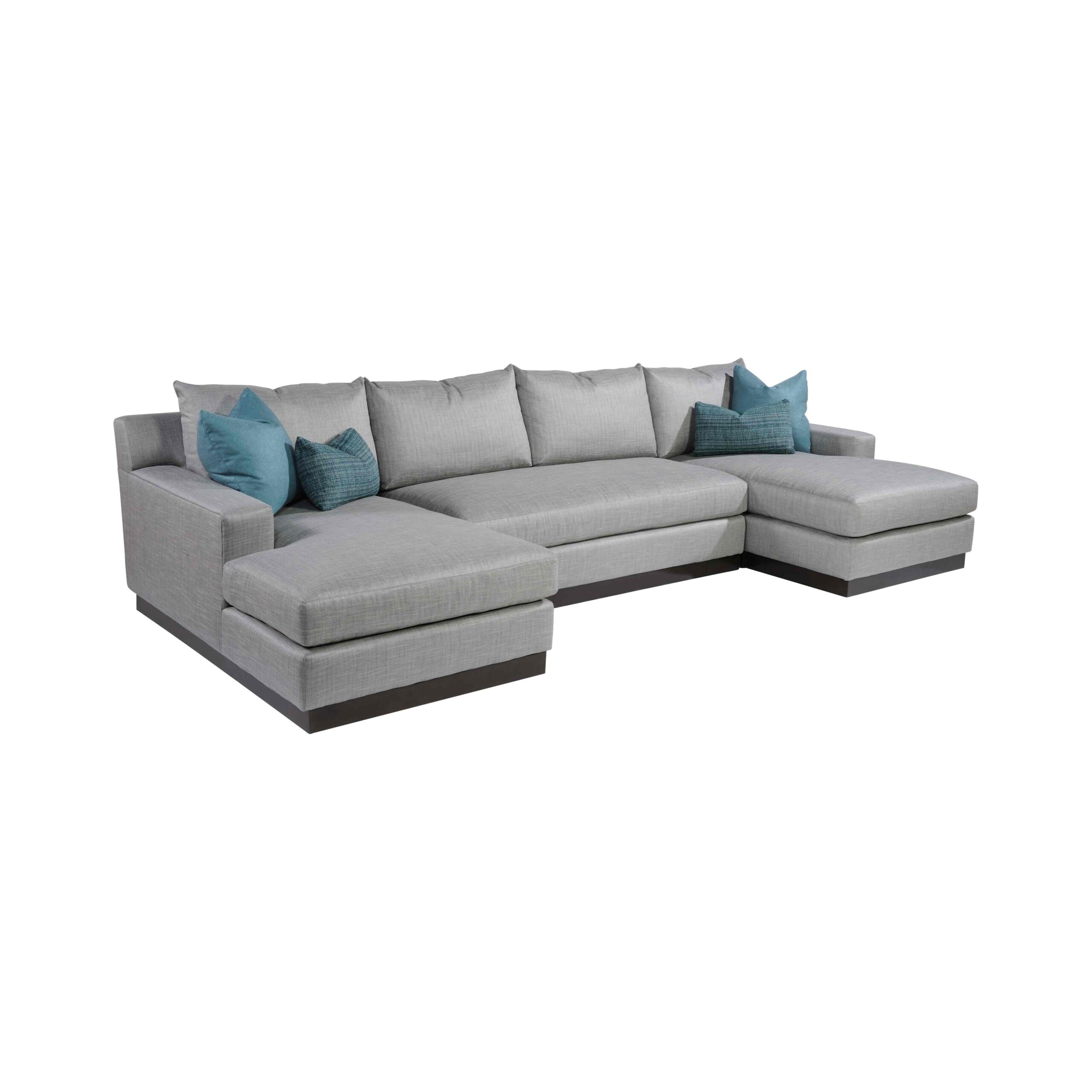 eaton sectional A light gray U-shaped sectional sofa with turquoise pillows.