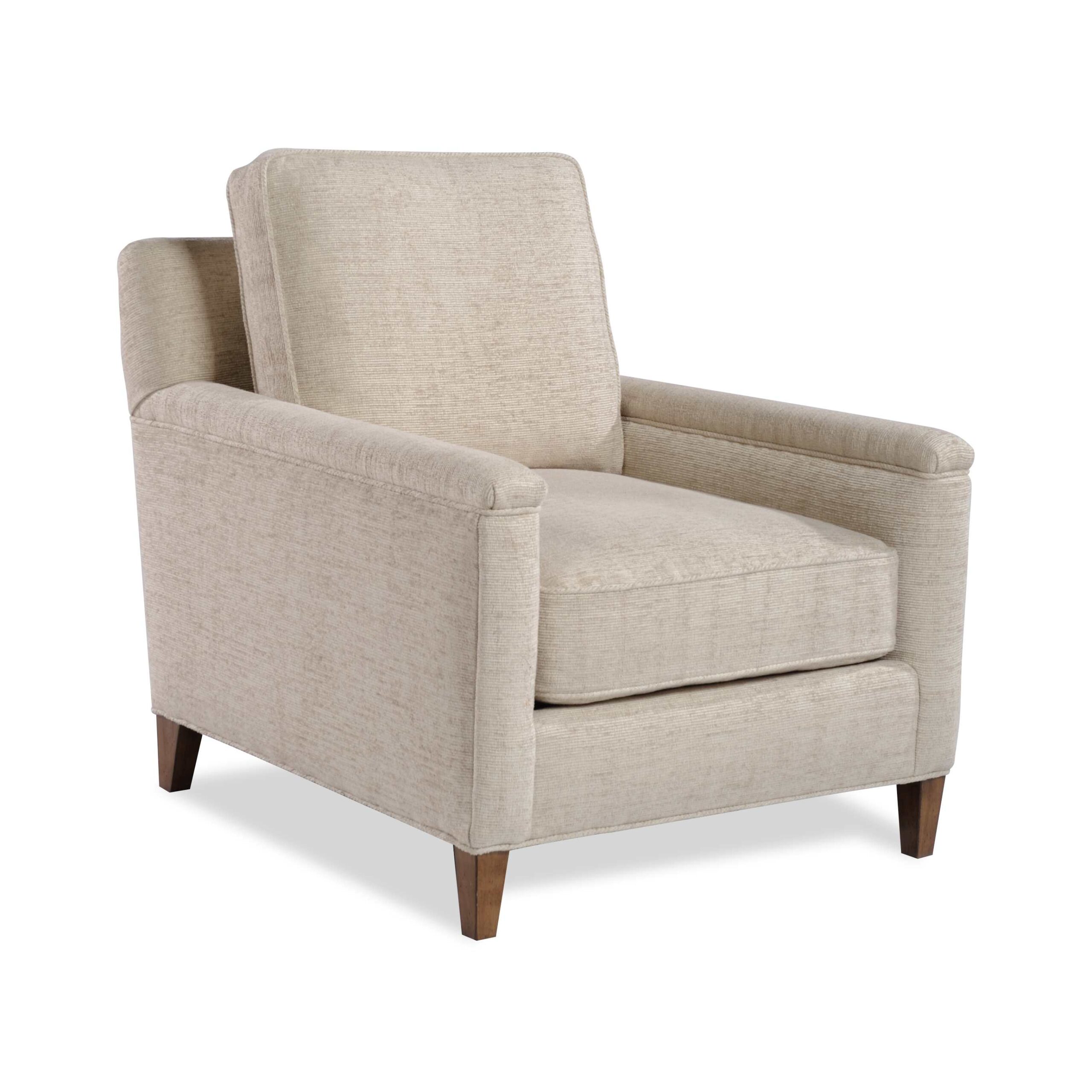 malloy chair Light beige textured armchair with tapered wooden legs.