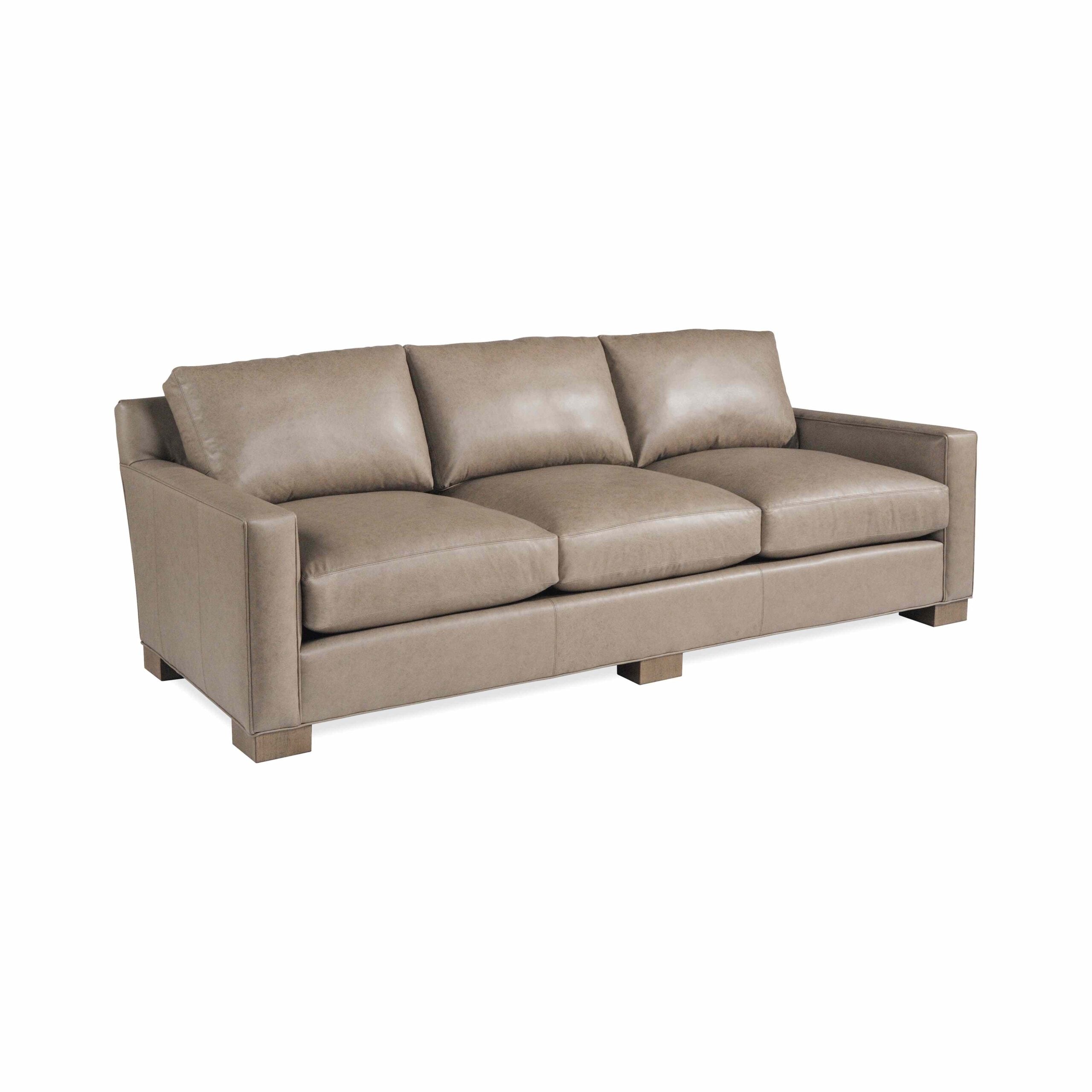 taylor made leather urban sofa Modern three-seater tan leather sofa with square block feet.