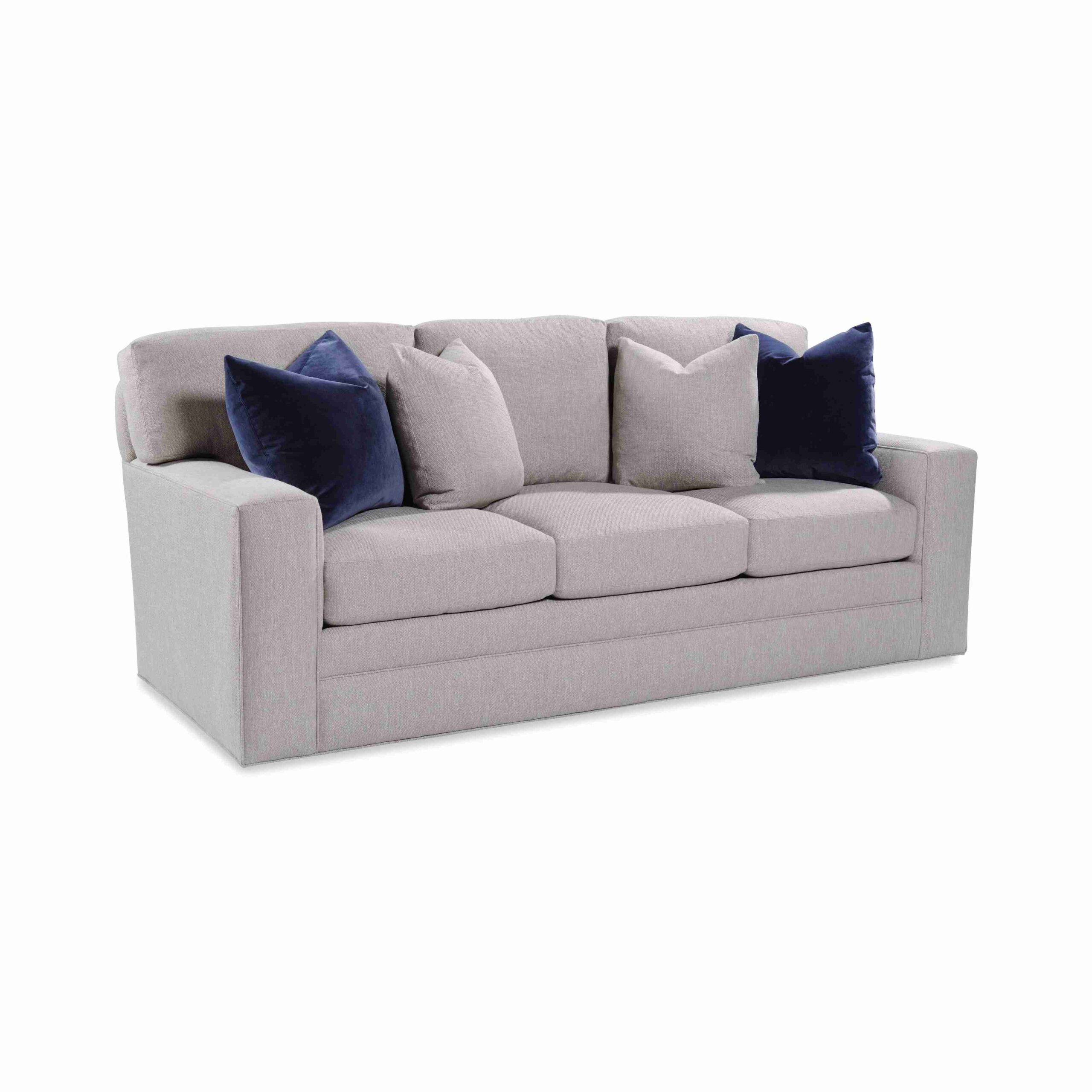taylor made plush sofa Light gray upholstered sofa with navy blue accent pillows.